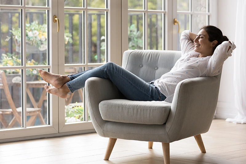 Woman in chair enjoying the air conditioning in her home