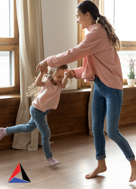 Mom and daughter dancing on hardwood floors